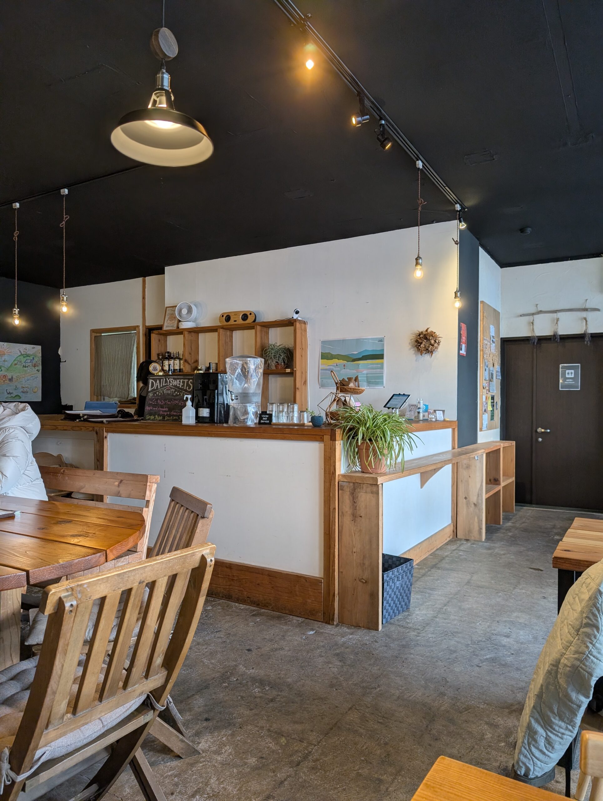 めぐりやの店内、木のカウンターと裸電球の照明