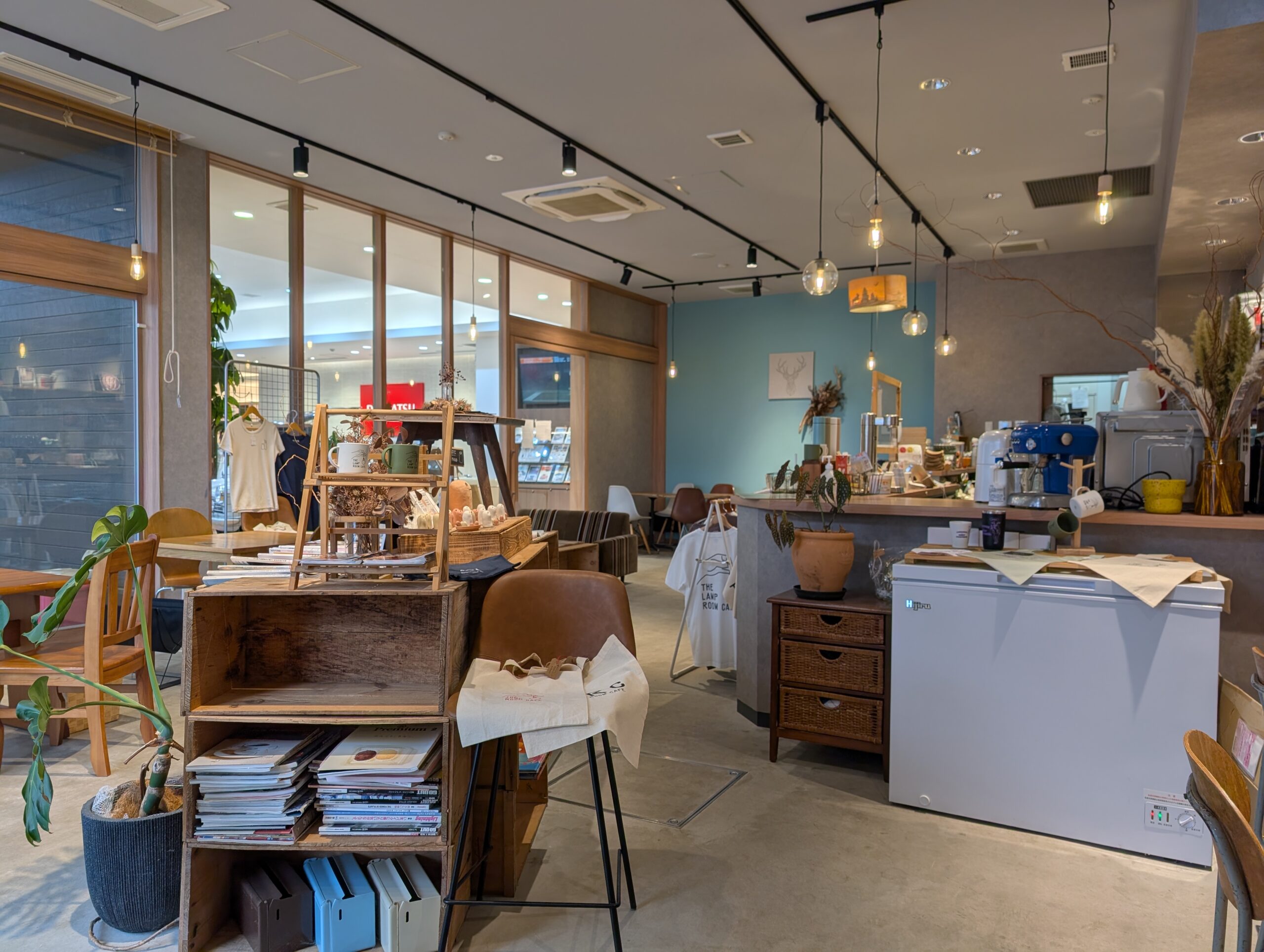 THE LAMP ROOM CAFEの店内。ブルーグリーンのアクセントウォールとペンダントライト